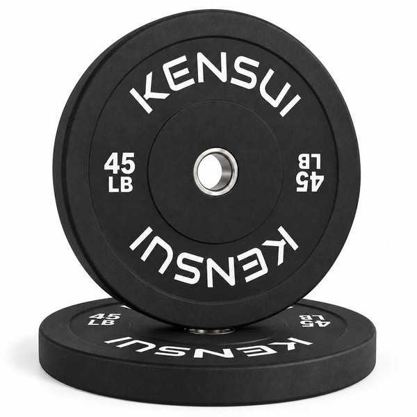 Pair of Kensui 45 lb black bumper plates, one upright on a matching flat plate, with white weight markings and steel inserts.