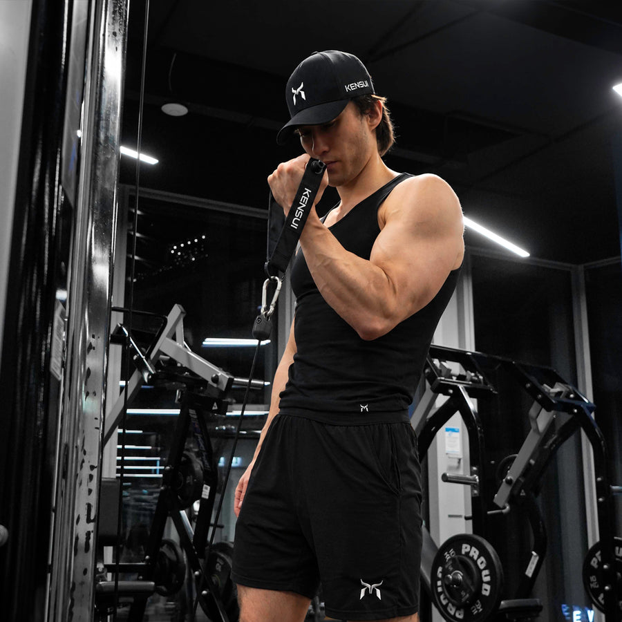 Kensui Woody Handle held near the shoulder during a single-arm cable exercise