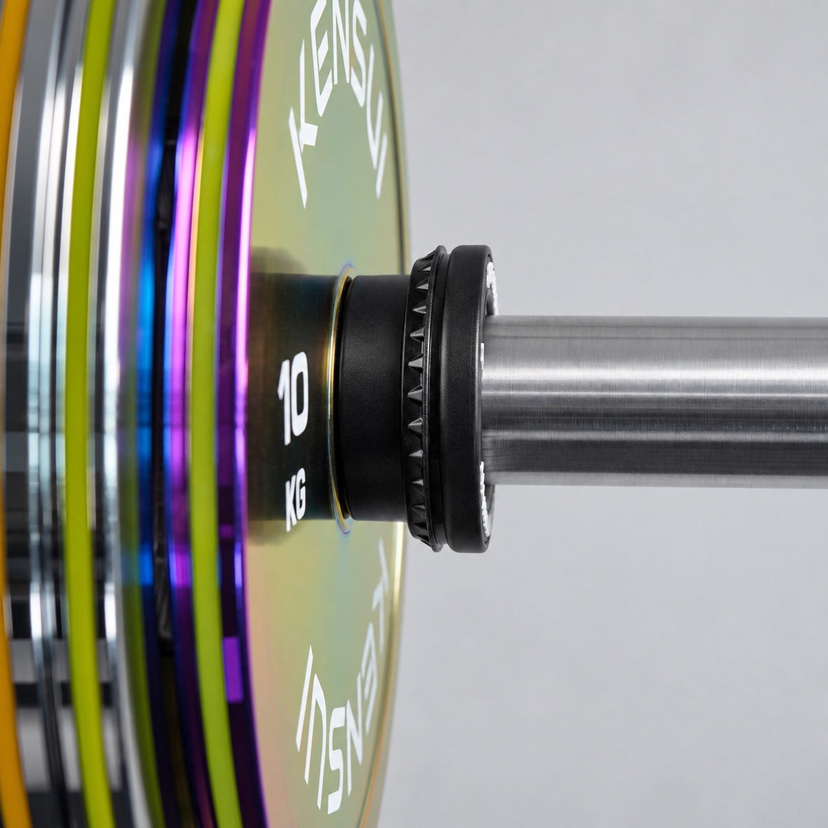 Kensui auto-lock collar securing an iridescent weight plate on an Olympic barbell sleeve