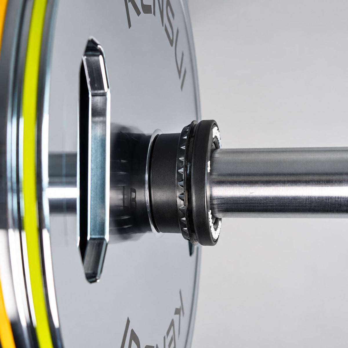 Kensui auto-lock collar securing a chrome grip weight plate on an Olympic barbell sleeve