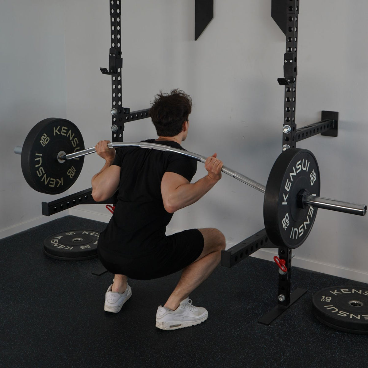 Athlete back squatting with the Beppu Buffalo bar