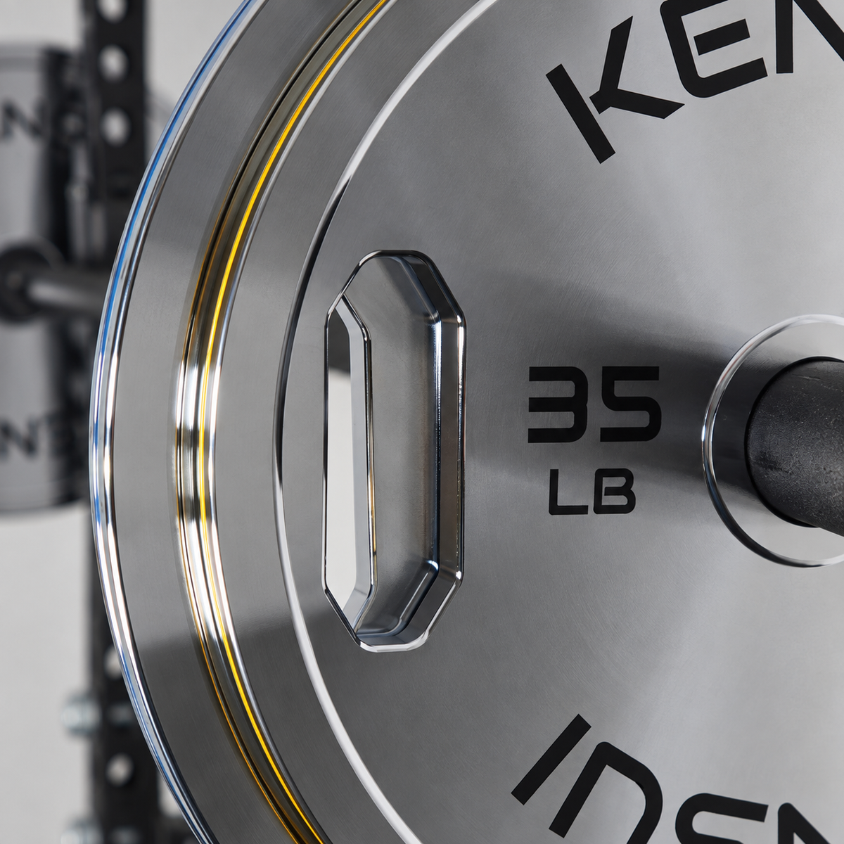 Close-up of the integrated grip opening, polished chrome edge and 35 LB marking on a Kensui calibrated plate.
