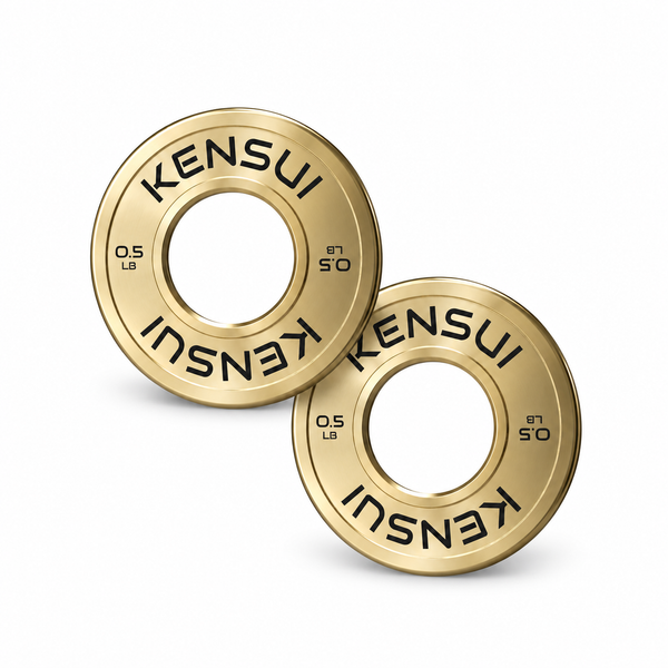 Pair of Kensui calibrated gold 0.5 lb microloading plates on a white background