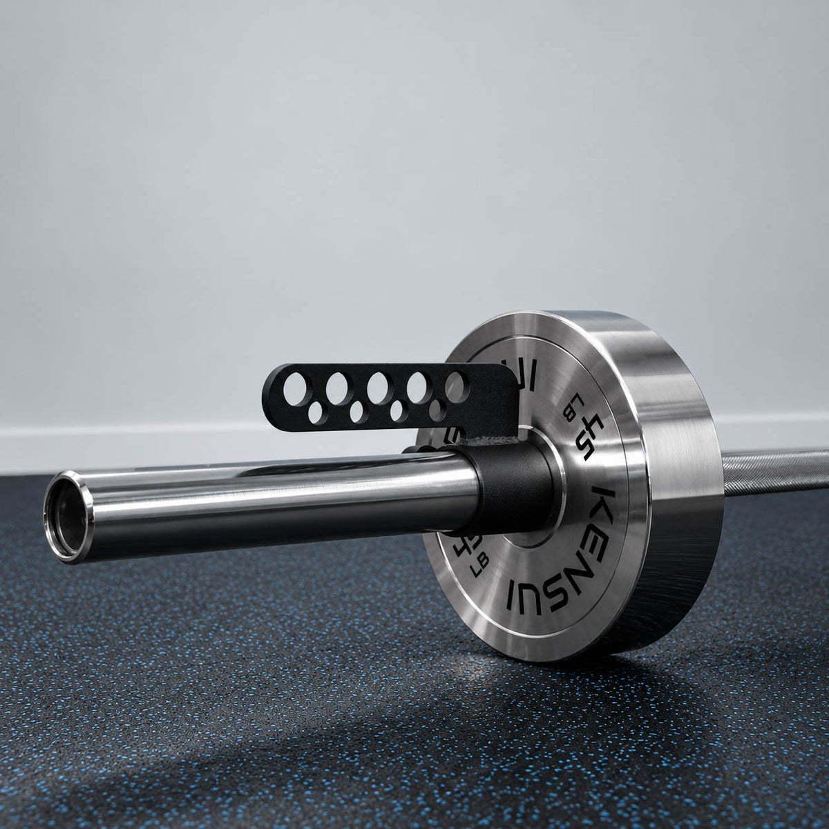 Kensui Landmine Belt Squat Attachment fitted to an Olympic barbell beside a weight plate