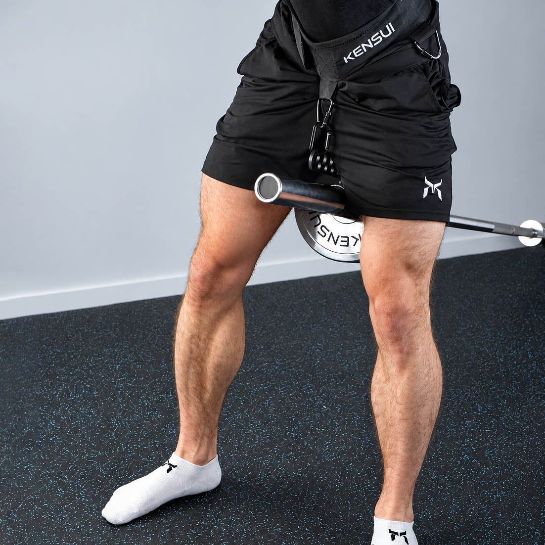 Standing belt squat position with a belt connected to the Kensui landmine attachment