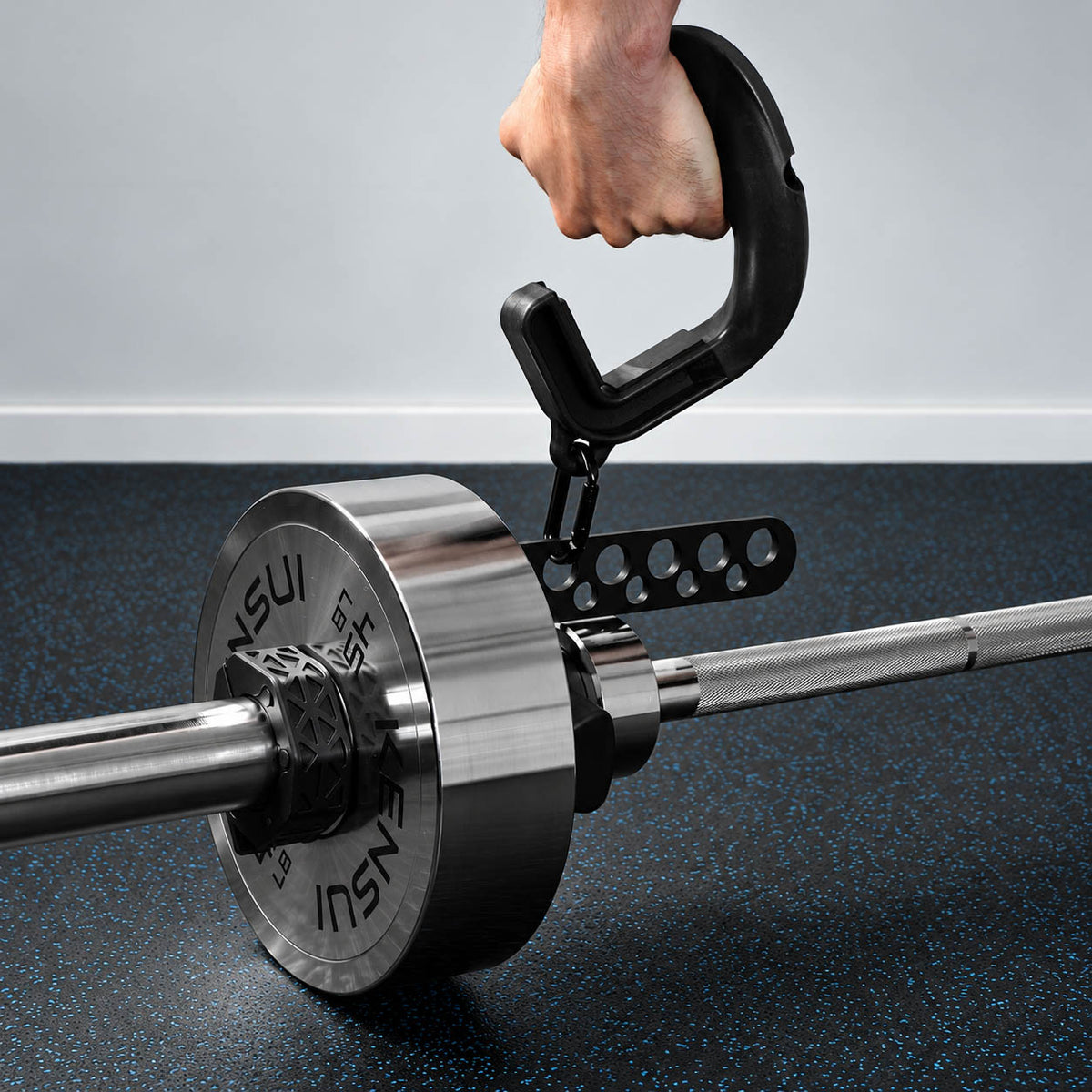 Close-up of a handle and carabiner lifting a loaded landmine barbell