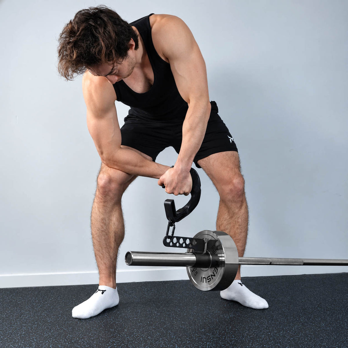 Athlete performing a single-arm landmine row with the Kensui attachment