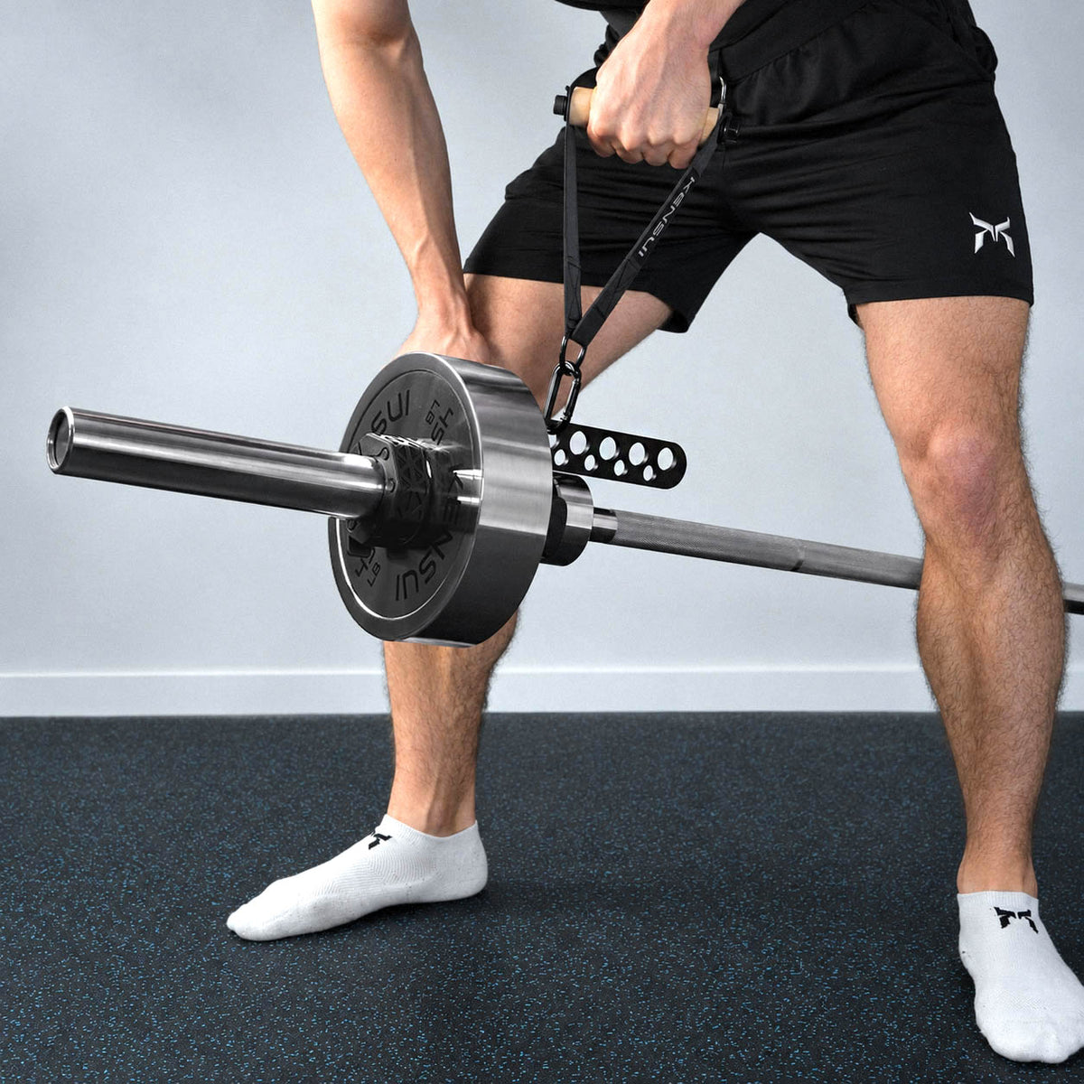 Athlete using a strap handle connected to the Kensui Landmine Belt Squat Attachment