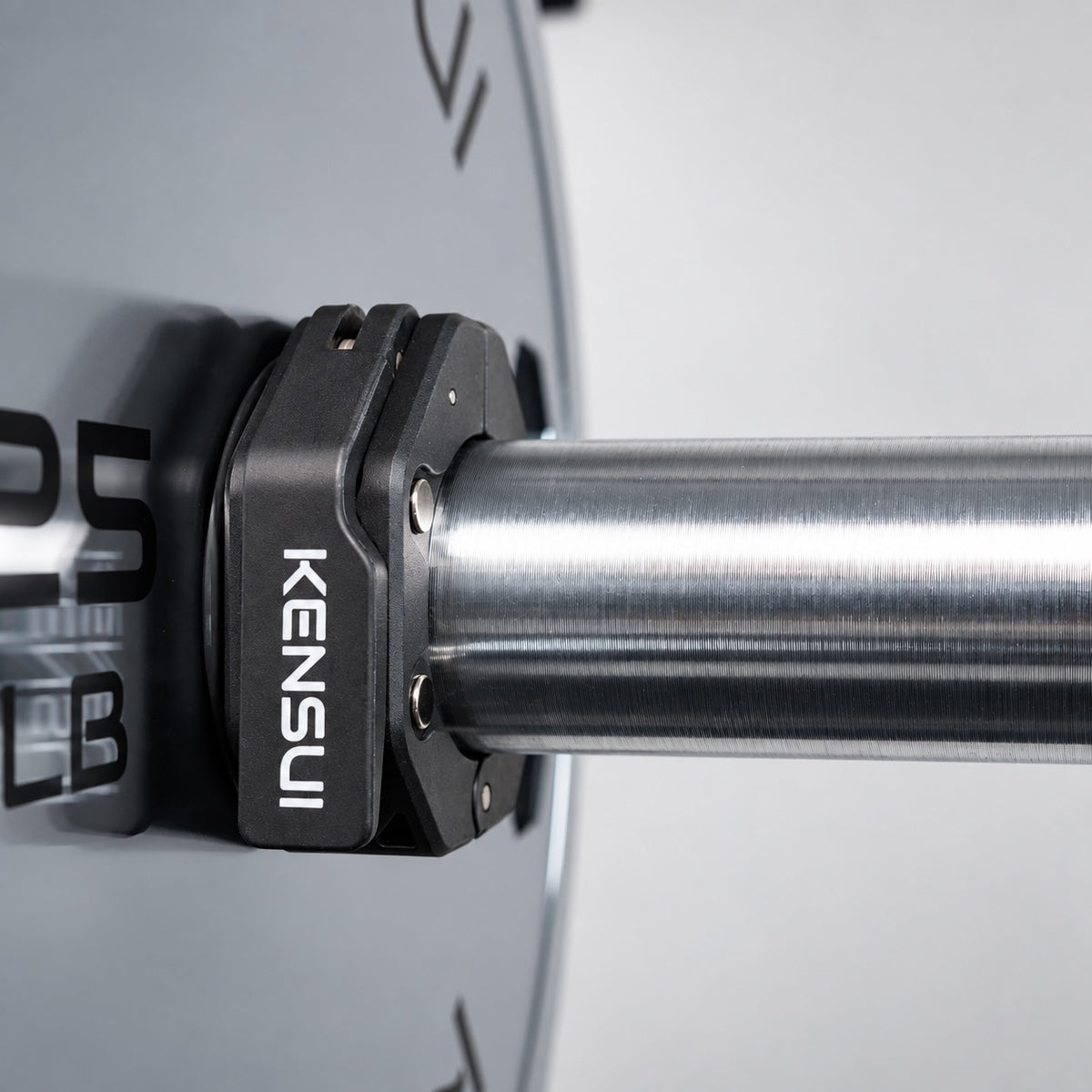 Kensui magnetic collar securing a weight plate on an Olympic barbell sleeve