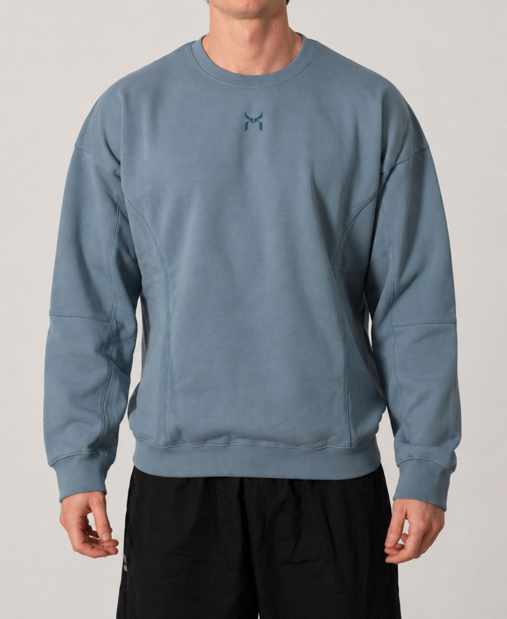 Nanakoribi Crew in blue, front view showing the relaxed drop-shoulder fit.