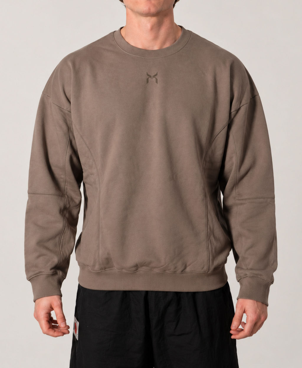 Nanakoribi Crew in taupe, front view showing the relaxed drop-shoulder fit.