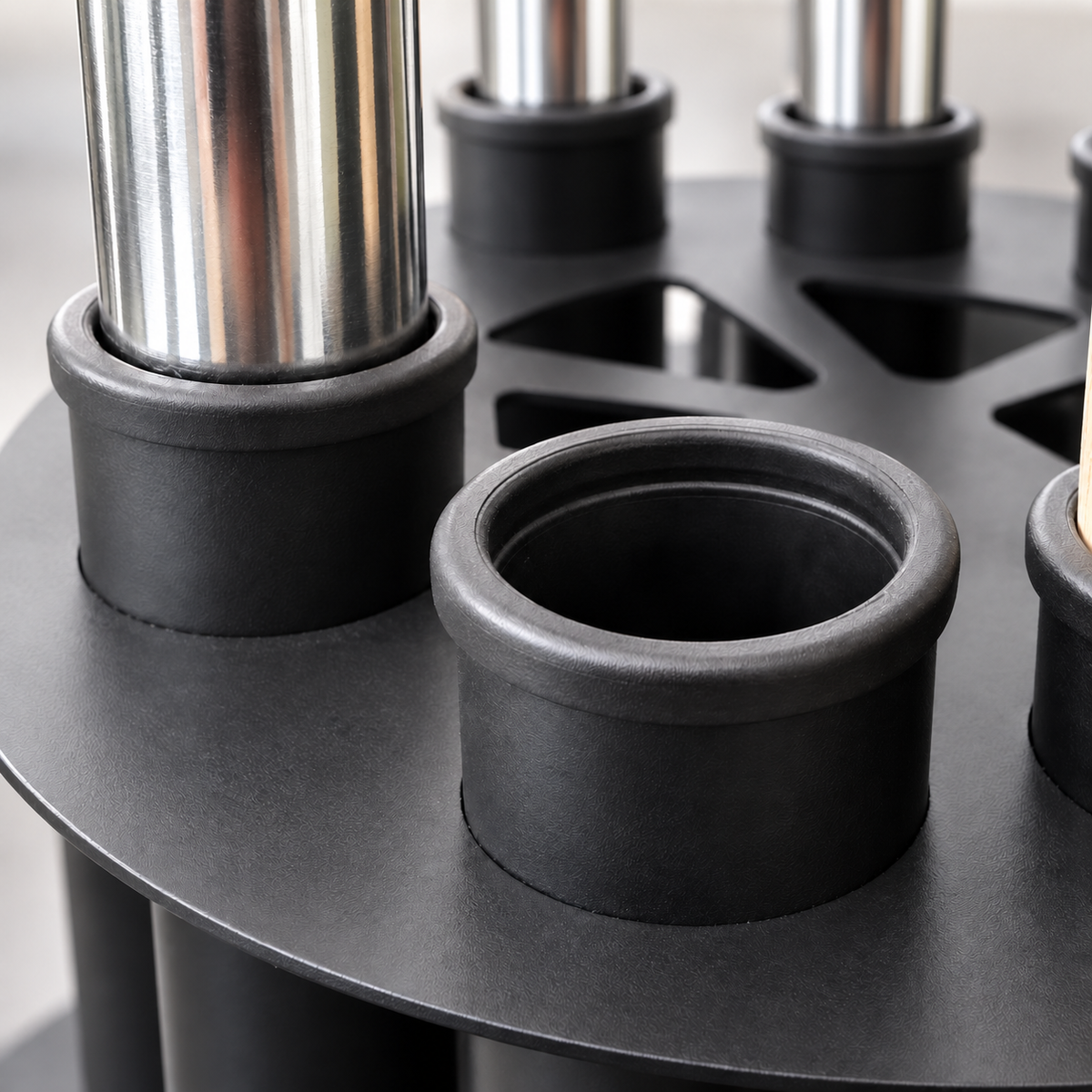 Close-up of the REVO RACK protective tube lining with chrome barbell sleeves