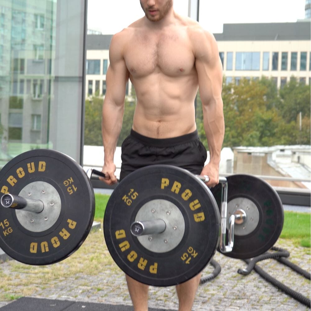 Athlete carrying the Tokyo open trap bar outdoors