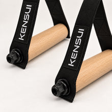 Load image into Gallery viewer, Close-up of two Woody Handles showing natural wood grain, stitching, and black end hardware