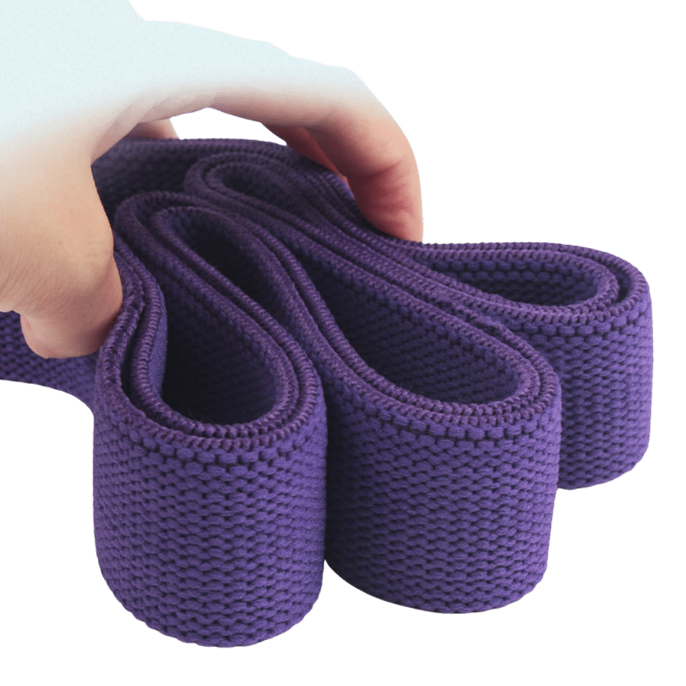 Hand holding a rolled purple fabric resistance band.