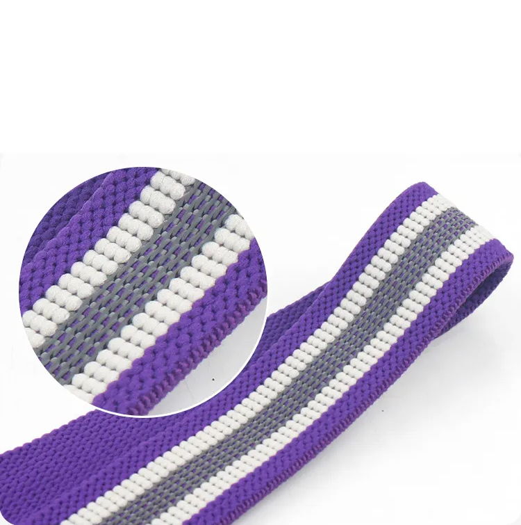 Close-up of the textured inner grip strips on a purple fabric resistance band.