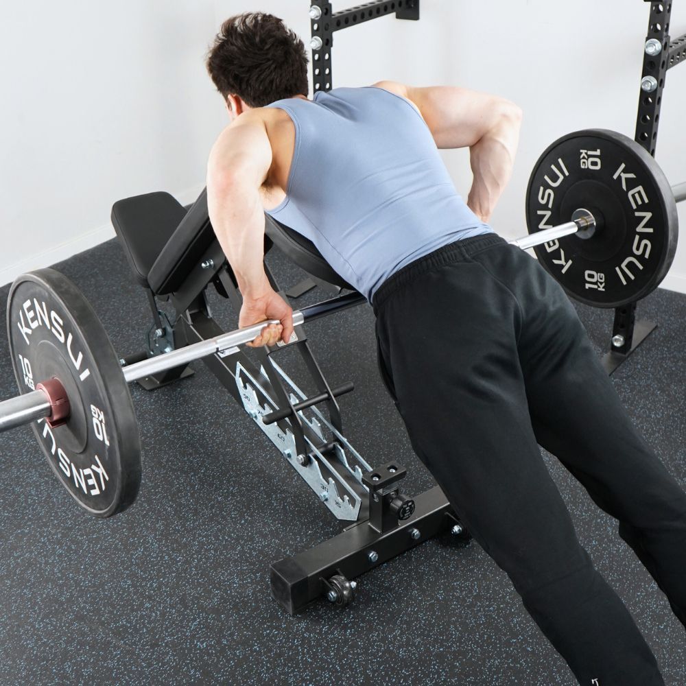 Person performing a barbell exercise on a bench in a gym.
