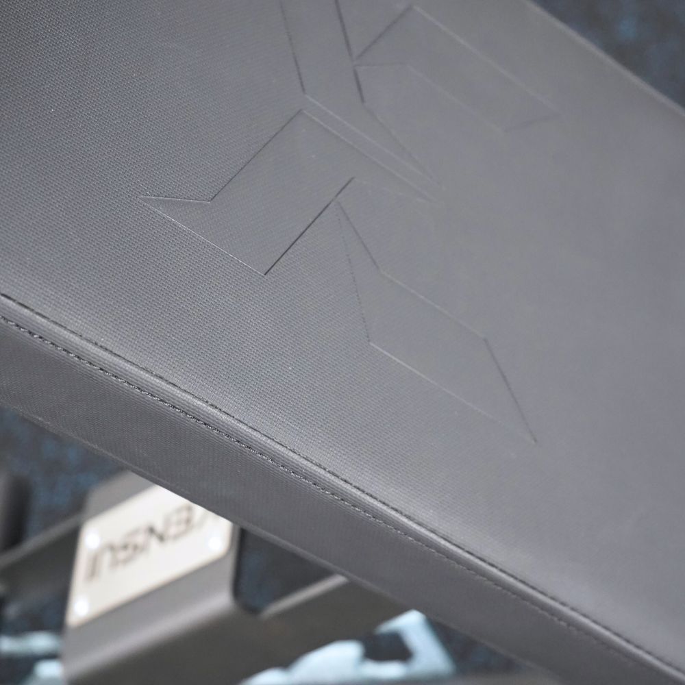 Close-up of the black bench upholstery and embossed Kensui emblem.