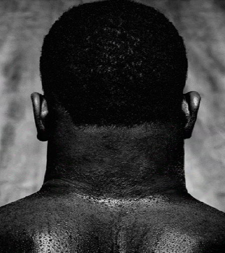 Rear view of a person's neck and shoulders.