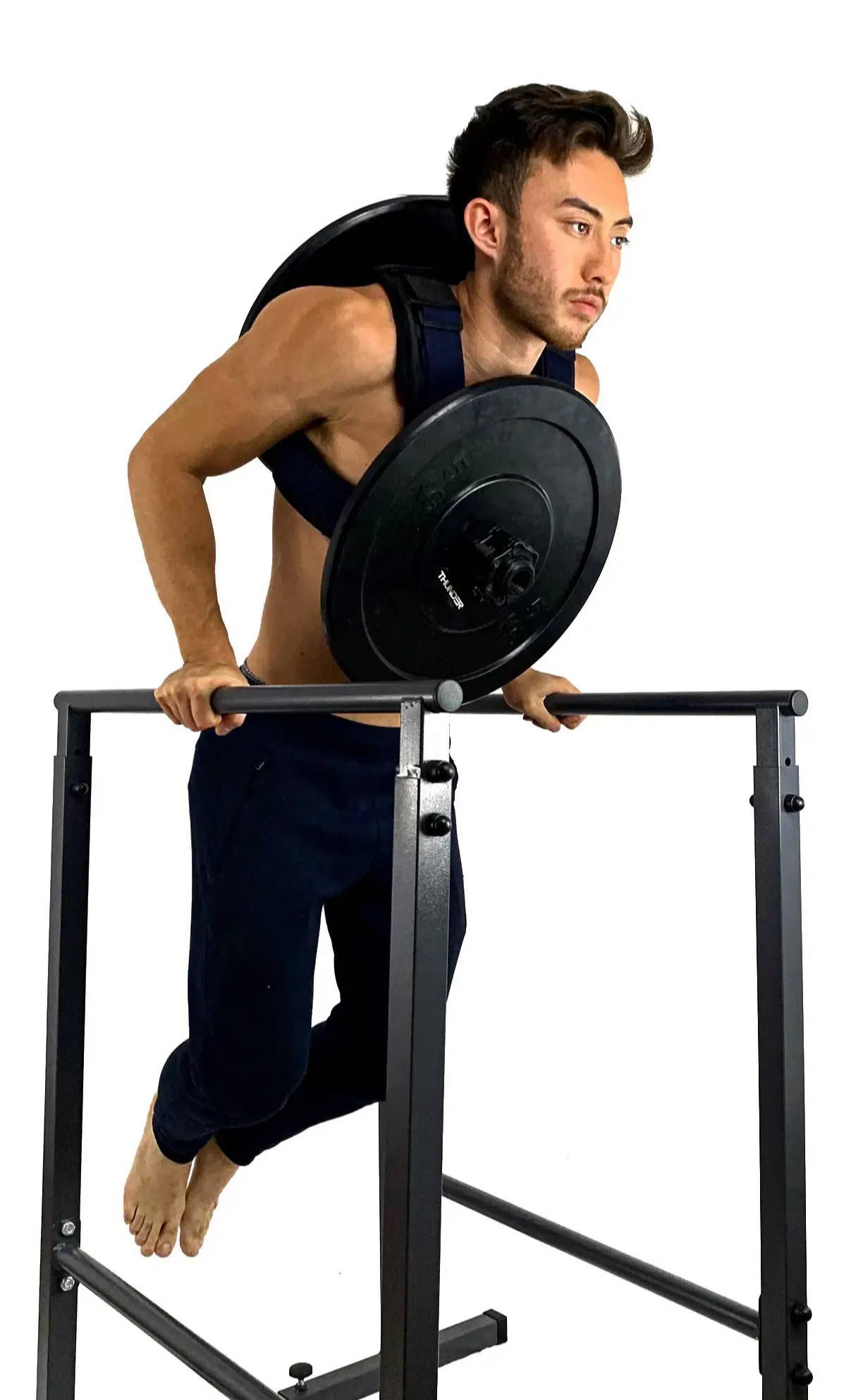 Person performing weighted dips on parallel bars.