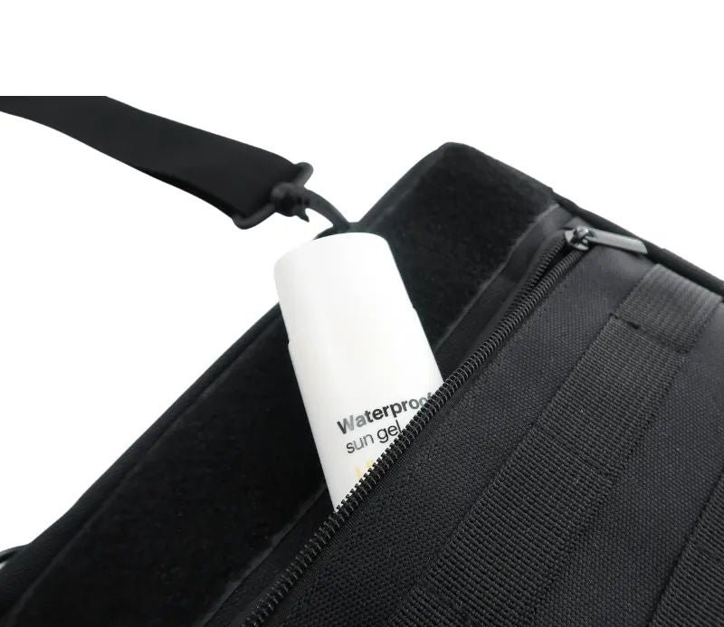 Open zippered pocket on a black carrying bag.